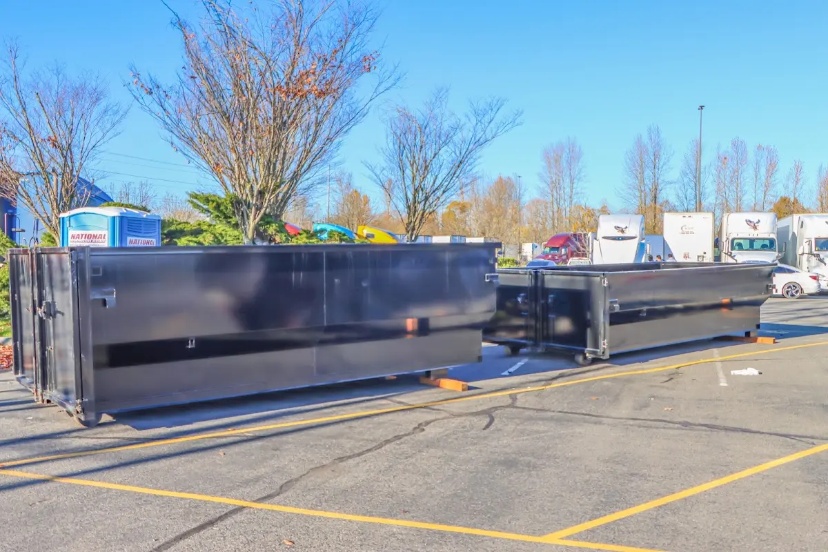 Professional dumpster rental service with roll-off container on residential driveway in Gloversville